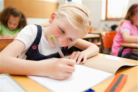 simsearch:6109-06007455,k - Little girl focused on her exercise book Stock Photo - Premium Royalty-Free, Code: 6109-06007402