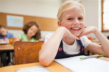 simsearch:400-05896357,k - Smiling little girl sitting at desk in class Stock Photo - Premium Royalty-Free, Code: 6109-06007405