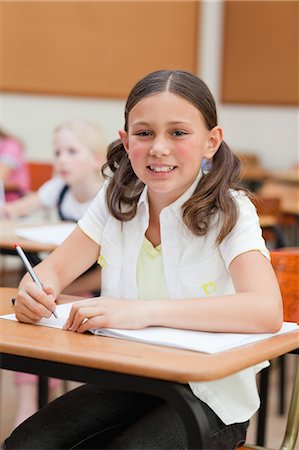 simsearch:6109-06007455,k - Smiling little girl at her desk in school Stock Photo - Premium Royalty-Free, Code: 6109-06007422