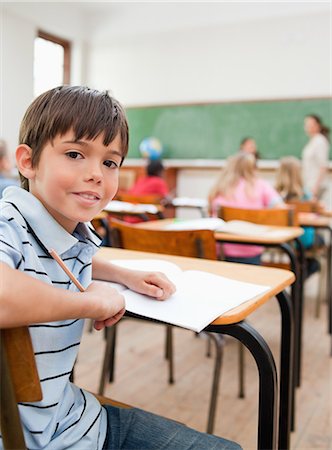 primary - Little schoolboy turned around in class Stock Photo - Premium Royalty-Free, Code: 6109-06007515