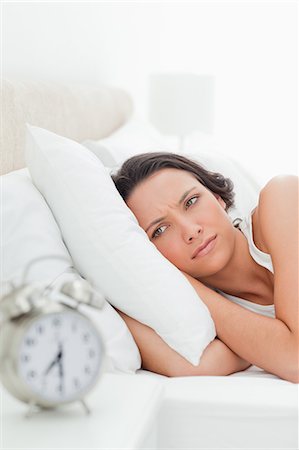 simsearch:6109-06194878,k - Woman who just wakes up with alarm clock Stock Photo - Premium Royalty-Free, Code: 6109-06194165