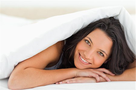 Woman with green eyes under the duvet Stock Photo - Premium Royalty-Free, Code: 6109-06194191