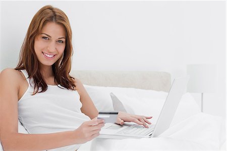 personal - Portrait of a redheaded woman shopping online on her laptop Stock Photo - Premium Royalty-Free, Code: 6109-06194497