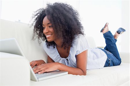 personal - Cute fuzzy hair woman surfing the internet Stock Photo - Premium Royalty-Free, Code: 6109-06194619