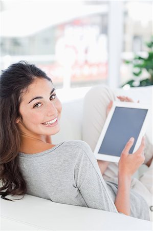 student room - Portrait of a smiling brunette using a touchpad Stock Photo - Premium Royalty-Free, Code: 6109-06194867