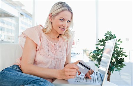 shopping online - Portrait of a blonde shopping online Stock Photo - Premium Royalty-Free, Code: 6109-06195043