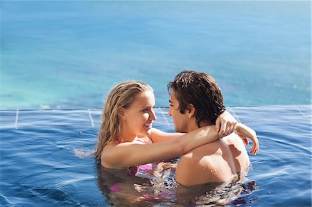 Side view of couple hugging in the pool Stock Photo - Premium Royalty-Free, Code: 6109-06195088