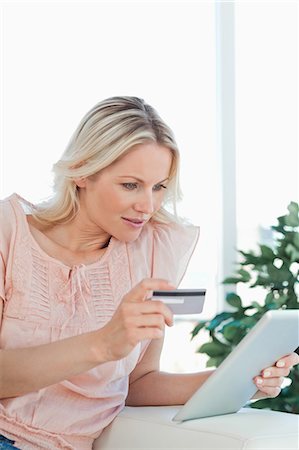 people holding cards in hand - Blonde buying online with a touchpad Stock Photo - Premium Royalty-Free, Code: 6109-06195025