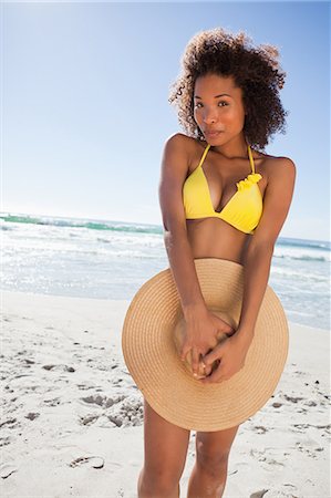 simsearch:6109-06004195,k - Young happy woman hiding her bikini with her straw hat Stock Photo - Premium Royalty-Free, Code: 6109-06195277