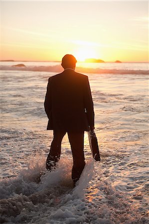 Young businessman walking in the water Stock Photo - Premium Royalty-Free, Code: 6109-06195406