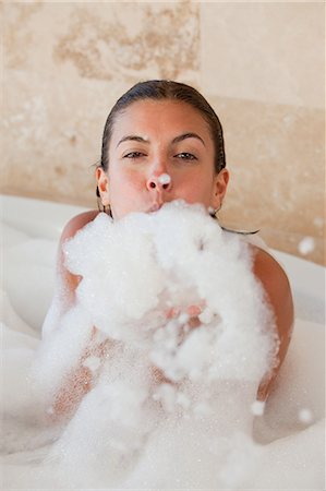 Woman in the tub blowing foam Stock Photo - Premium Royalty-Free, Code: 6109-06195742