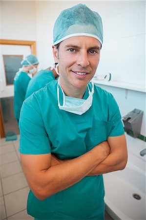surgeon - Smiling surgeon with his arms folded Stock Photo - Premium Royalty-Free, Code: 6109-06196044