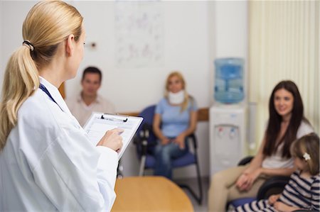 Female doctor talking to patient in a waiting room Stock Photo - Premium Royalty-Free, Code: 6109-06196095