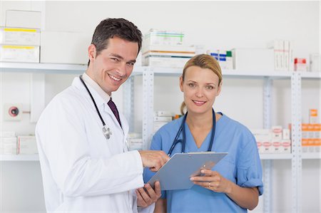 Smiling pharmacist with a nurse in a pharmacy Stock Photo - Premium Royalty-Free, Code: 6109-06196099