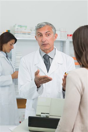 patient tablet - Pharmacist explaining something to a customer Stock Photo - Premium Royalty-Free, Code: 6109-06196197