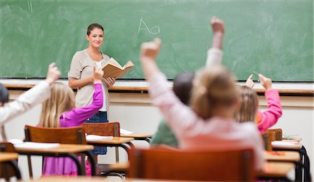 Teacher about to pick one of her students Stock Photo - Premium Royalty-Free, Code: 6109-06196397