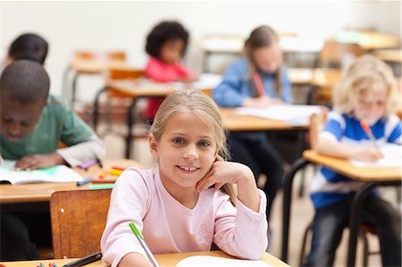 Smiling girl sitting in the classroom Stock Photo - Premium Royalty-Free, Code: 6109-06196481