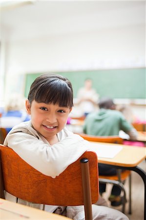 Smiling elementary school student not paying attention Stock Photo - Premium Royalty-Free, Code: 6109-06196413