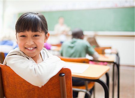 Smiling schoolgirl not paying attention Stock Photo - Premium Royalty-Free, Code: 6109-06196412