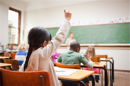 Back view of young student raising hand Stock Photo - Premium Royalty-Free, Code: 6109-06196414