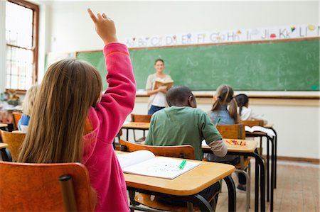 school book - Back view of girl raising hand during lesson Stock Photo - Premium Royalty-Free, Code: 6109-06196425