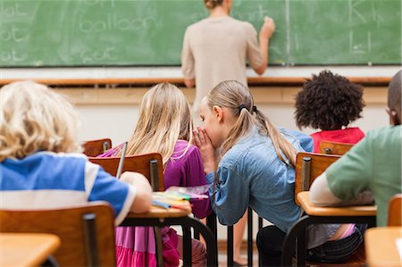 Back view of elementary school students talking Stock Photo - Premium Royalty-Free, Code: 6109-06196437