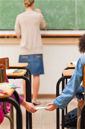 simsearch:6109-06196438,k - Back view of girl giving schoolfellow a letter Stock Photo - Premium Royalty-Free, Code: 6109-06196438