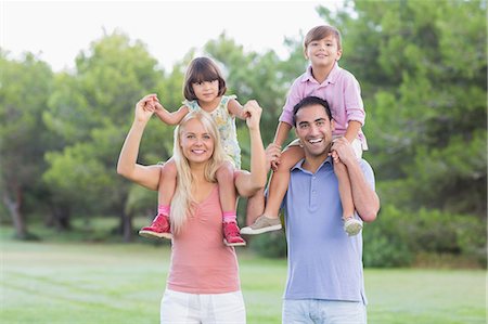 piggy back ride mom and child - Portrait of happy family with children on parents shoulders Stock Photo - Premium Royalty-Free, Code: 6109-06684765