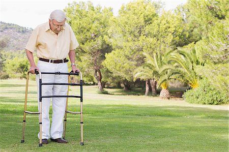 Elderly man using zimmer frame to walk Stock Photo - Premium Royalty-Free, Code: 6109-06684844