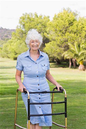 Elderly woman using a zimmer frame to walk Stock Photo - Premium Royalty-Free, Code: 6109-06684845