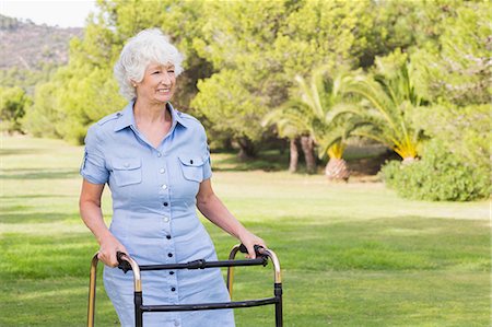 Happy elderly woman with zimmer frame Stock Photo - Premium Royalty-Free, Code: 6109-06684846