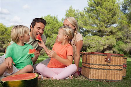 Happy family having a picnic and eating watermelon Stock Photo - Premium Royalty-Free, Code: 6109-06684970