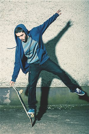 skate - Skater doing truck stand on his board Stock Photo - Premium Royalty-Free, Code: 6109-06781432