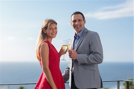 simsearch:400-05686653,k - Lovely couple toasting with their flutes of champagne Stock Photo - Premium Royalty-Free, Code: 6109-06781594