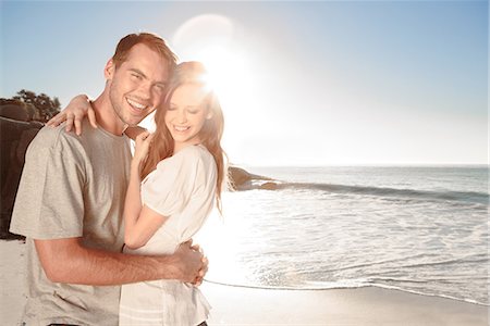 sunset couple water - Couple embracing and posing on the beach Stock Photo - Premium Royalty-Free, Code: 6109-06781672