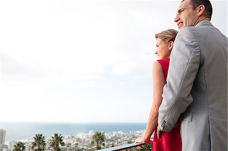 sophisticate - Lovely couple standing on their balcony Foto de stock - Sin royalties Premium, Código: 6109-06781622