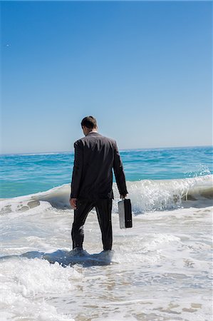 simsearch:6109-06684997,k - Businessman walking into the sea Stock Photo - Premium Royalty-Free, Code: 6109-06781634