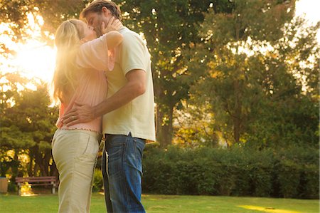 Beautiful couple kissing in a park Stock Photo - Premium Royalty-Free, Code: 6109-06781726