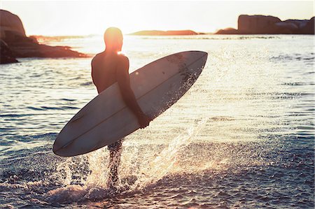 silhouette walking with surfboard - Silhouette of a surfer walking in the sea Stock Photo - Premium Royalty-Free, Code: 6109-06781820