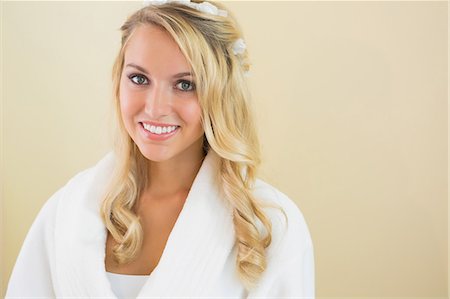 Cheerful gorgeous bride smiling at camera wearing a bath robe Stock Photo - Premium Royalty-Free, Code: 6109-07497382