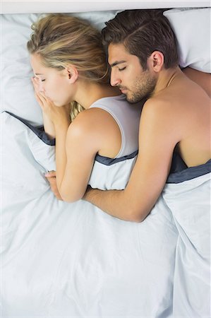 simsearch:6109-07497311,k - Relaxed couple sleeping and spooning in bed in the bedroom Stock Photo - Premium Royalty-Free, Code: 6109-07497339