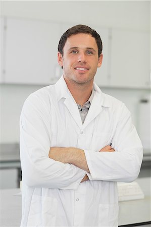 scientist - Attractive young scientist posing in laboratory with arms crossed smiling at camera Stock Photo - Premium Royalty-Free, Code: 6109-07497751