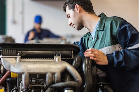 Instructor checking a machine in workshop Stock Photo - Premium Royalty-Free, Code: 6109-07497962