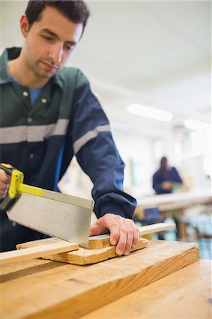 simsearch:400-07899762,k - Serious carpenter sawing wood in workshop Stock Photo - Premium Royalty-Free, Code: 6109-07497975