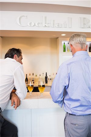 sophisticated man - Business colleagues with beer glasses at bar counter Stock Photo - Premium Royalty-Free, Code: 6109-07600949