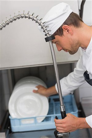 simsearch:6109-07601170,k - Kitchen porter cleaning plates in sink Stock Photo - Premium Royalty-Free, Code: 6109-07601149