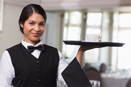 Pretty waitress holding a tray with a cup Stock Photo - Premium Royalty-Free, Code: 6109-07601187