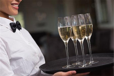 drink - Pretty waitress holding a tray of champagne Photographie de stock - Premium Libres de Droits, Code: 6109-07601189