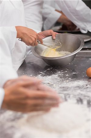 Chef preparing pastry at counter Stock Photo - Premium Royalty-Free, Code: 6109-07601113