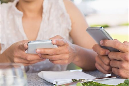 dating - Couple on a date sending text messages Stock Photo - Premium Royalty-Free, Code: 6109-07601228